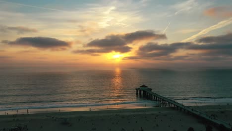 Sunset-Scenery-At-Manhattan-Beach-Pier-In-California,-USA---aerial-drone-shot