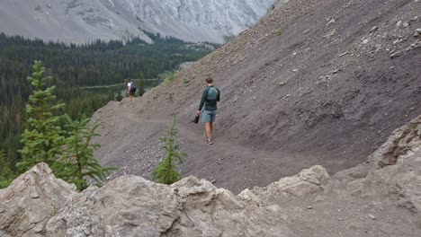 hikers on trail in mountain kanasakis alberta canada