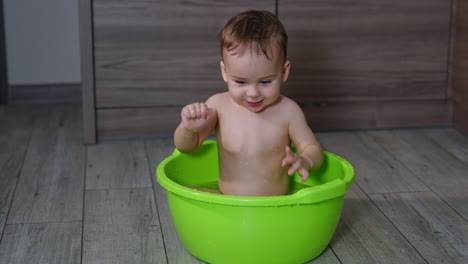 baby playing in a plastic bath