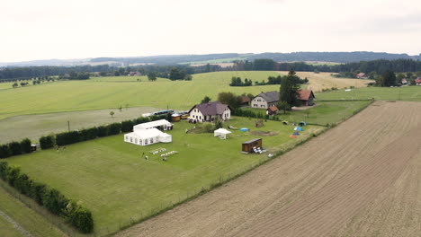 Invitados-Reunidos-En-Una-Casa-De-Campo,-Preparándose-Para-Una-Boda-Al-Aire-Libre