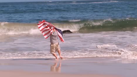 a person holding american flag feet in the sea