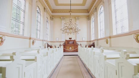 entering empty church nave stylish interior design, daytime, dolly in