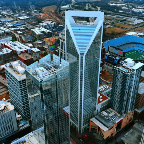 flying around the magnificent skyscrapers with mirror windows in the downtown of charlotte, north carolina, usa. city scenery on cloudy daytime.