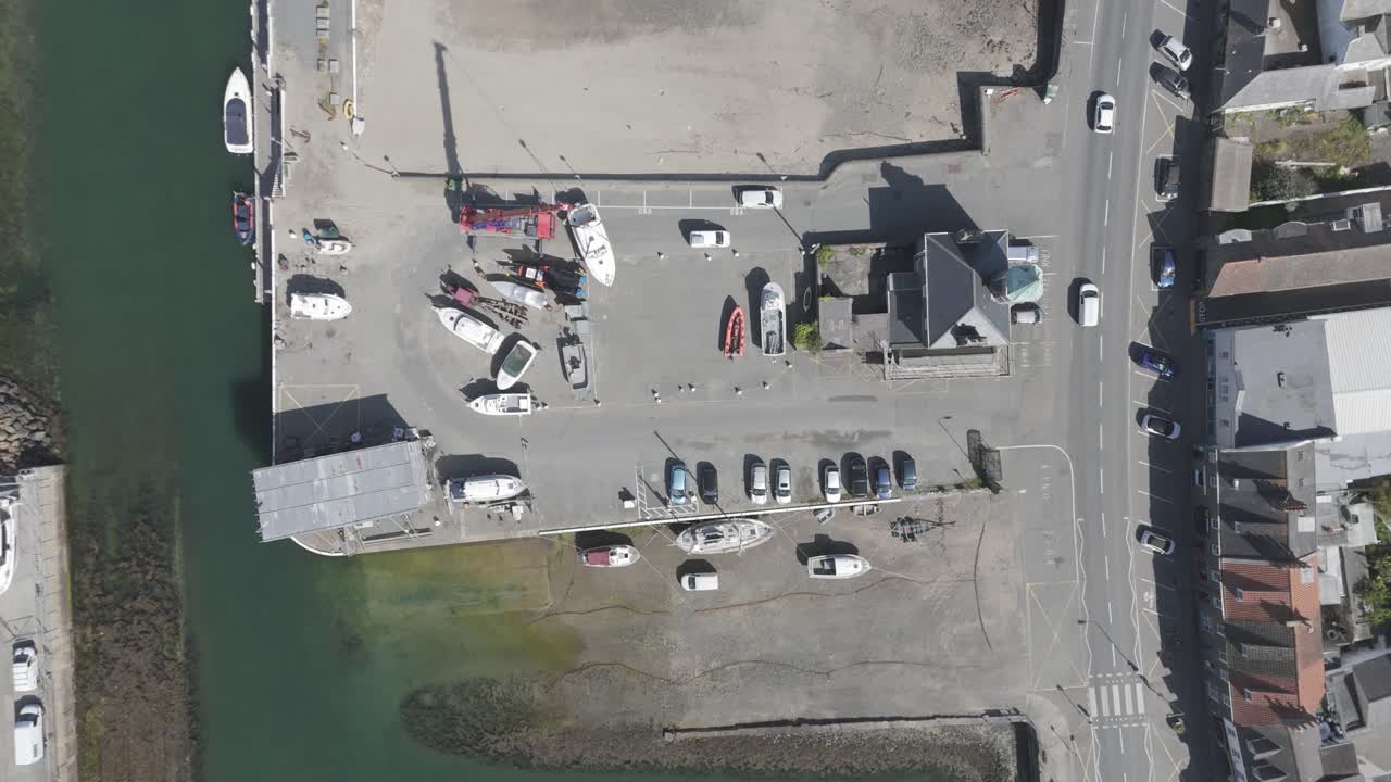 Guernsey St Sampsons harbour.Overhead drone flight of Southside from the Bridge to Bulwer Avenue showing marina,Le Crocq,commercial berths and clear water in the harbour entrance on bright sunny day