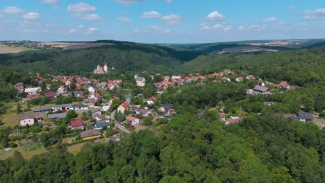 flying towards a czech village krivoklat with a castle on a sunny day