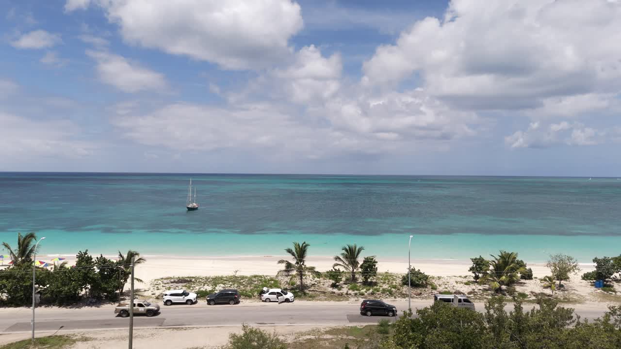 Boat Isolated Over Crystal Blue Waters With White Sand On Darkwood Beach In Antigua And Barbuda. Aerial Pullback Shot