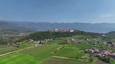 Scenic view of Vipava village surrounded by rolling hills and majestic mountains