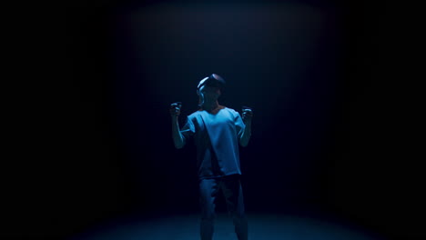 neon man experiencing virtual reality in dark cyberspace. focused player explore