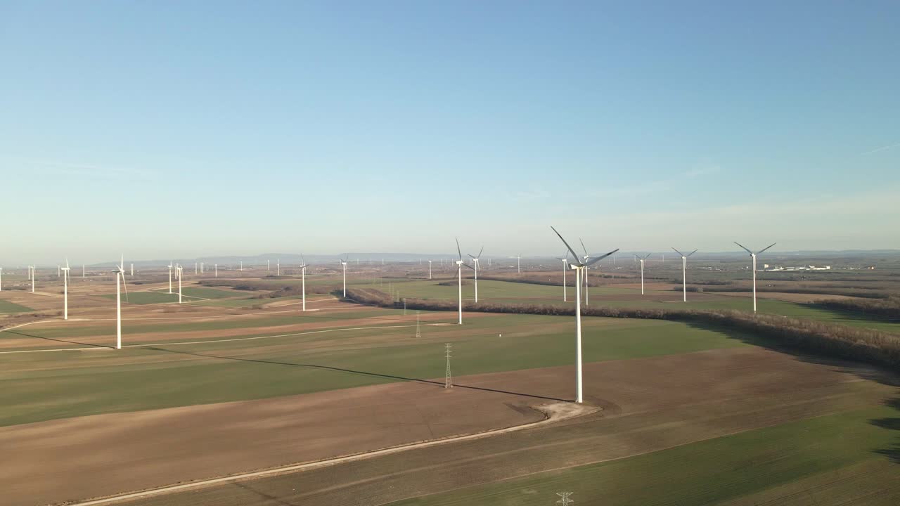 Aerial view of a wind farm with multiple turbines in rural landscape