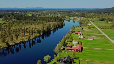 the calm water of västerdal river lies in äppelbo village, dalarna, sweden