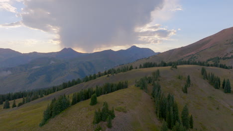 aerial of mountain range with push over ridge line towards sunset in the colorado rockies