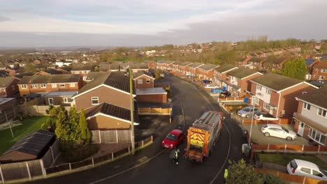 Aerial-View-of-Dustmen-putting-recycling-waste-into-a-waste-truck,-Bin-Men,-Recycling-day,-refuse-collection-in-Stoke-on-Trent,-Staffordshire