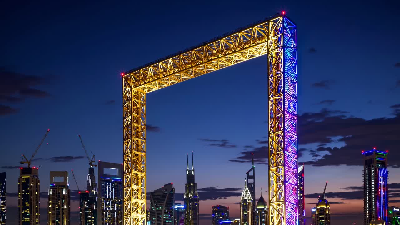 Illuminated Dubai Frame glowing at sunset, showcasing vibrant colors while framing the stunning city skyline and creating a breathtaking visual spectacle in the evening sky