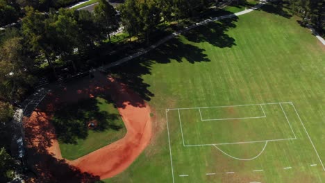 aerial rotation over a community park from the soccer and baseball field to the community pool