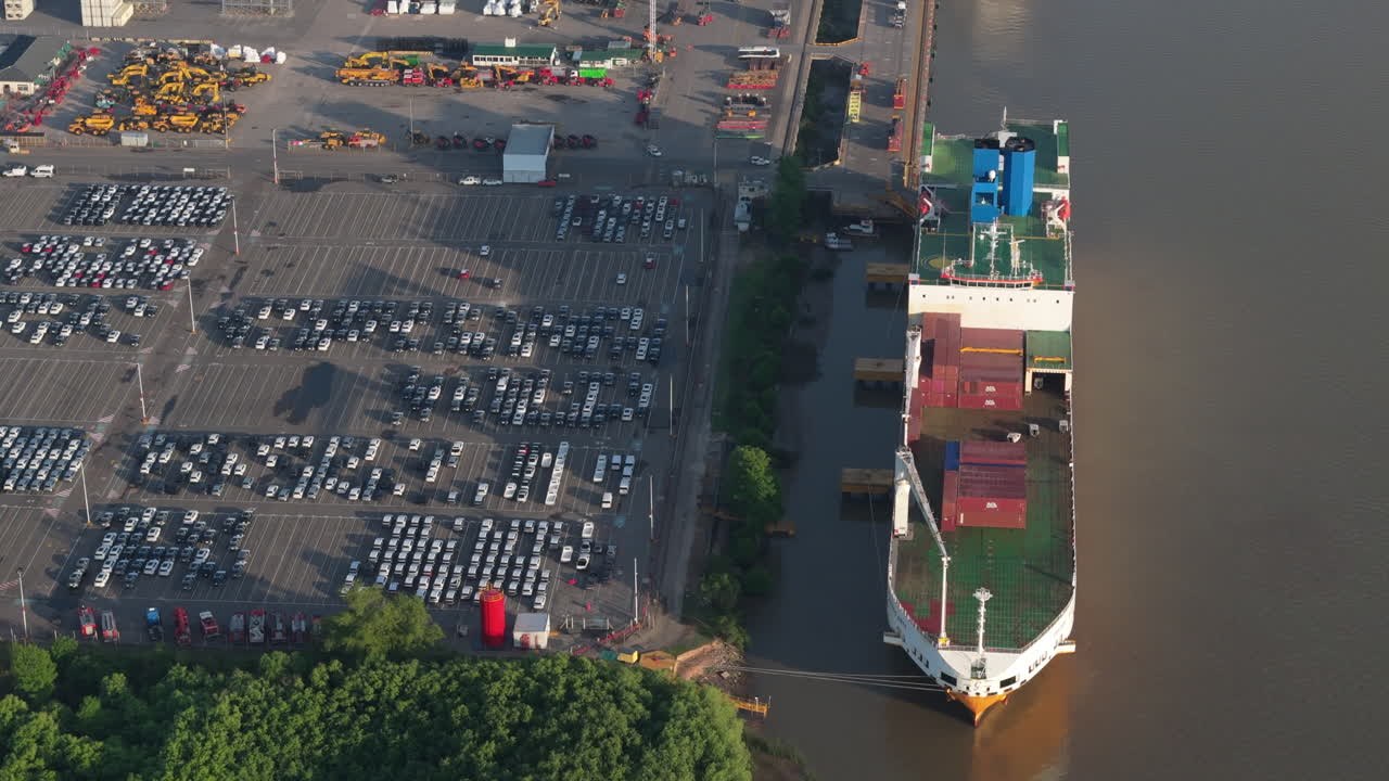 Aerial view of cargo ship moored at Terminal Zárate Port full of vehicles and machinery, Argentina