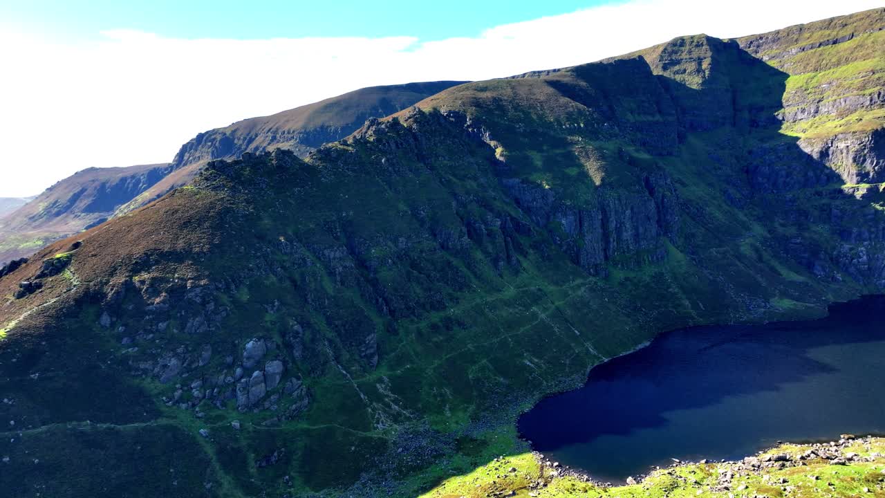 Irish mountains drone reveal of Coumshingaun Lake surrounded by high cliffs Epic locations in Ireland