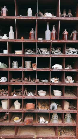 vintage rusty metal storage cabinet filled with old items