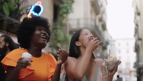 two women enjoying ice cream in the city