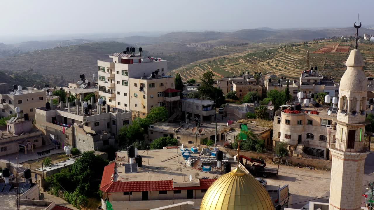 Aerial View of a Palestinian Village with a Golden-Domed Mosque and Minaret