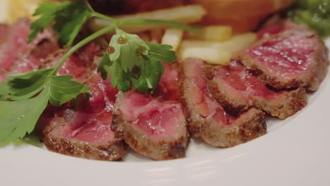 steak on plate with fries, juicy freshly cooked meat