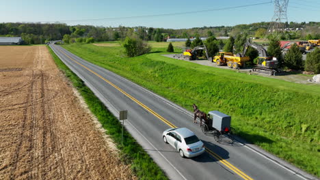 amish horse and buggy pass heavy equipment