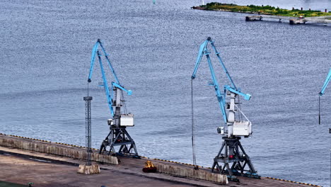 several harbor cranes in a drone view