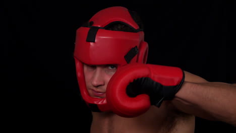 tough boxer punching with red gloves