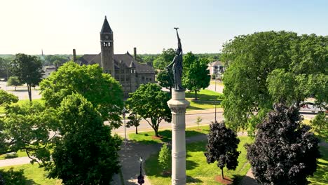 the statute at hackley park with the hackley building behind