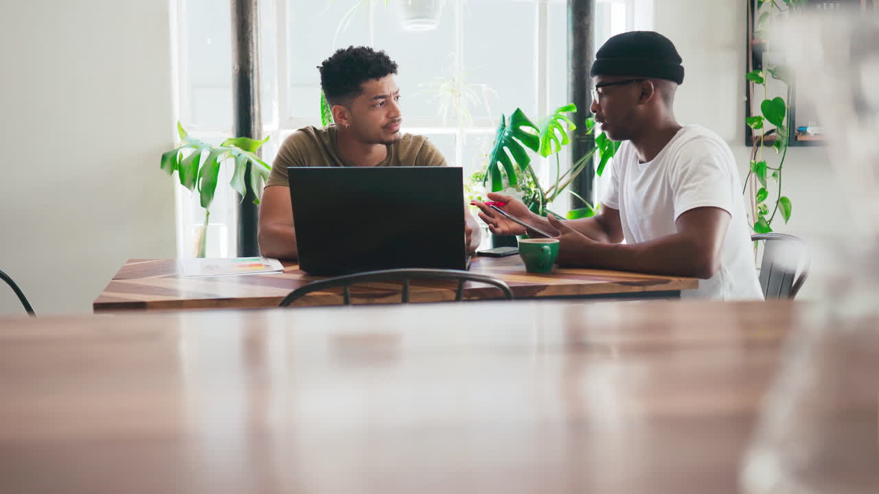 two young men chatting over coffee in a coffee