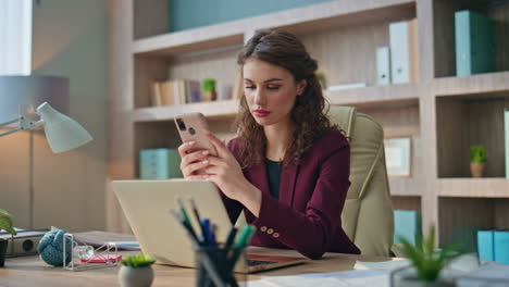frustrated businesswoman reading sms at work. shocked manager receive bad news