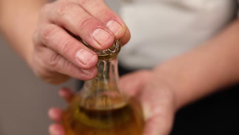 pouring oil from a container into another