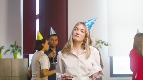 happy blonde woman dancing and having fun at the office party 1