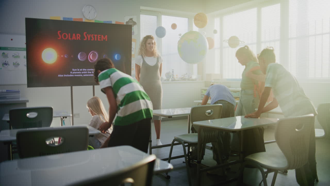 Female Teacher Greeting Young Boys and Girls at the Beginning of Astronomy Lesson