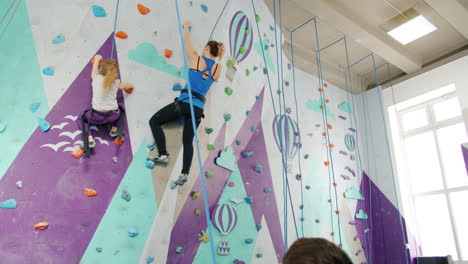 mother and daughter rock climbing