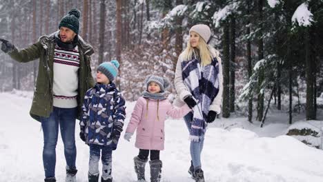 Video-Portátil-De-Una-Familia-Caminando-En-El-Bosque-Invernal.