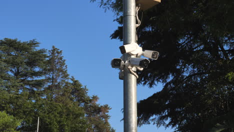 panning shot of security cameras on a mast drive by