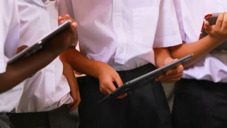 students using digital tablet in classroom
