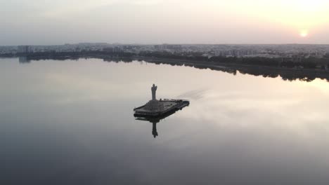 A-aerial-beautiful-sunrise-over-the-Indian-city-of-Hyderabad-cinematic-footage-of-Hyderabad's-most-famous-area,-Hussain-Sagar-Lake