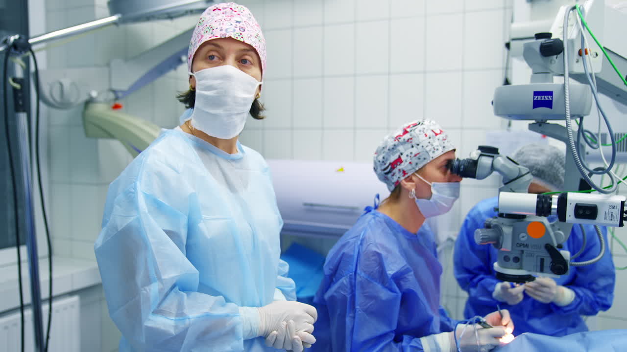 Ophthalmologists performing operation on eyes. Doctors during process of conducting surgical operations on eye