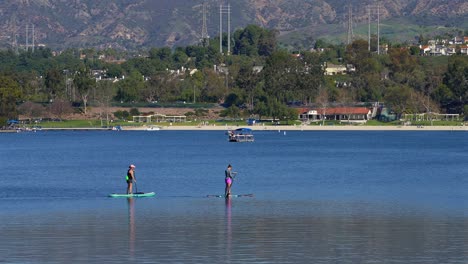 two female paddle boarders on lake mission viejo in southern california