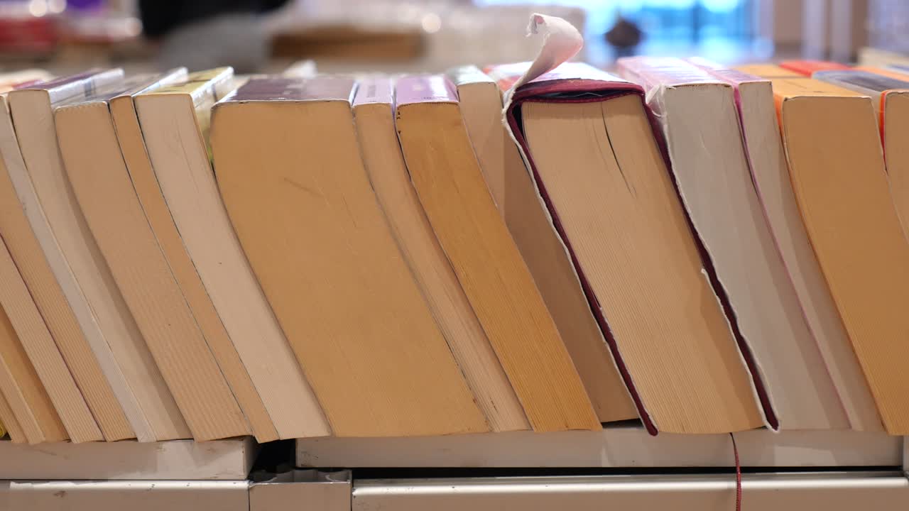 Old Books Leaning on a Shelf in a Library