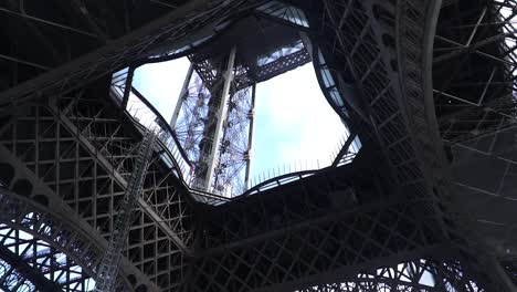 renovation of eiffel tower under the first platform in paris, france