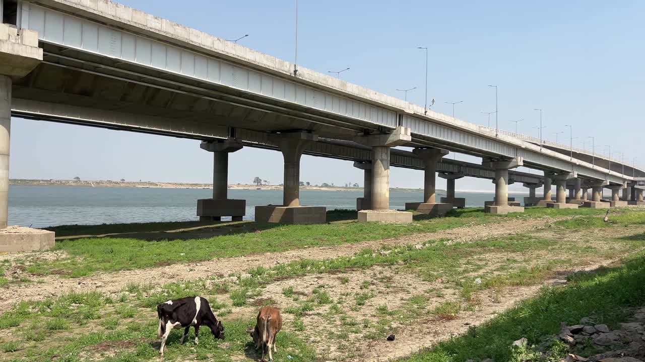View of a bridge constructed with steel girders and concrete supports by the shore in Patna, Bihar, India.