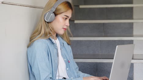 two asian girls student partners are working on a laptop help study together