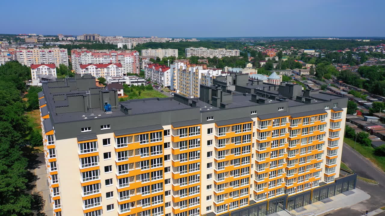 Contemporary block of flats among city landscape. Modern multi-storey building of new design. New landmark in the city. View from above.