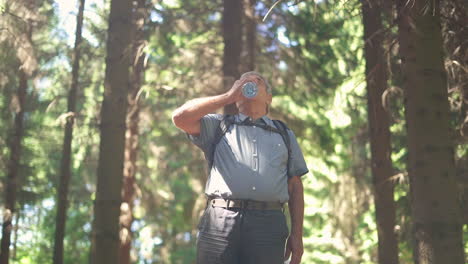 Man drinking water in the forest