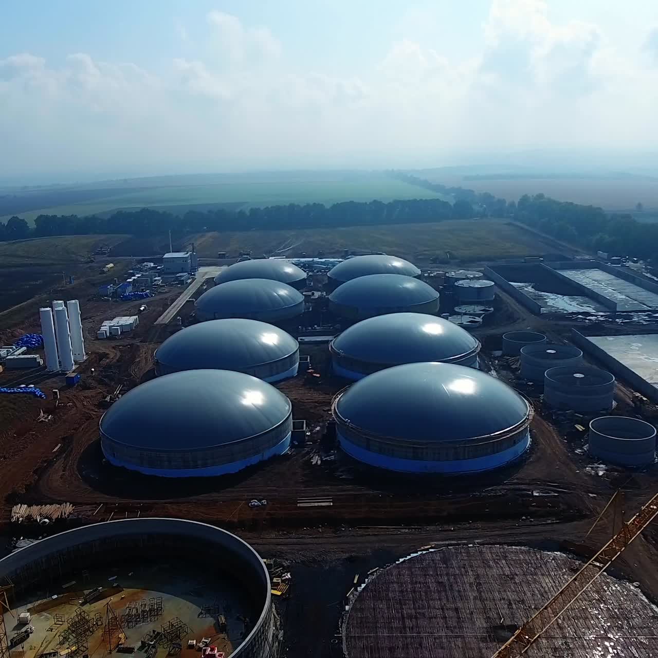 Construction zone of bio fuel plant. Bio gaz factory building in a field