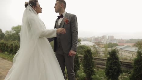 Lovely-newlyweds-caucasian-bride-groom-walking-in-park,-holding-hands,-wedding-couple-family