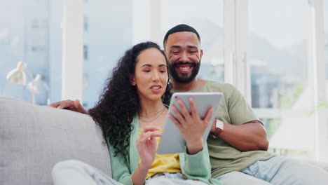 Tablet,-talking-and-couple-on-home-sofa-together