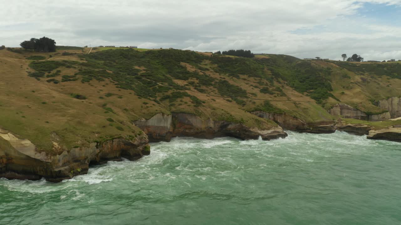 Aerial shot of cliffs during the day along the coastline in New Zealand